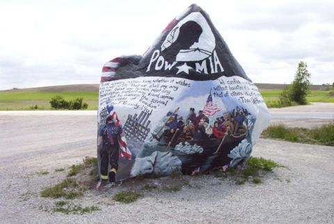 1981 Ford Bronco - A large rock painted with patriotic imagery, including the POW-MIA symbol and a depiction of Washington crossing the Delaware.