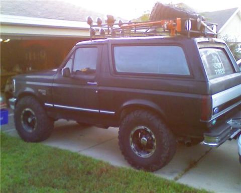 1994 Ford Bronco - This 1994 Ford Bronco is equipped with a roof rack and off-road tires, suggesting it is ready for adventure.