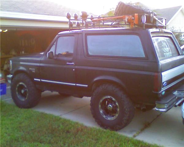 1994 Ford Bronco side view with roof rack and off-road tires