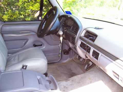 1994 Ford Bronco - The interior of a truck is shown, the driver's seat, dashboard, and steering wheel.