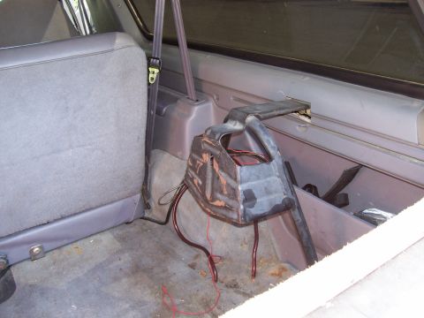 1994 Ford Bronco - Interior view of a 1994 Ford Bronco showing the cargo area, rear seat, and a metal bracket.
