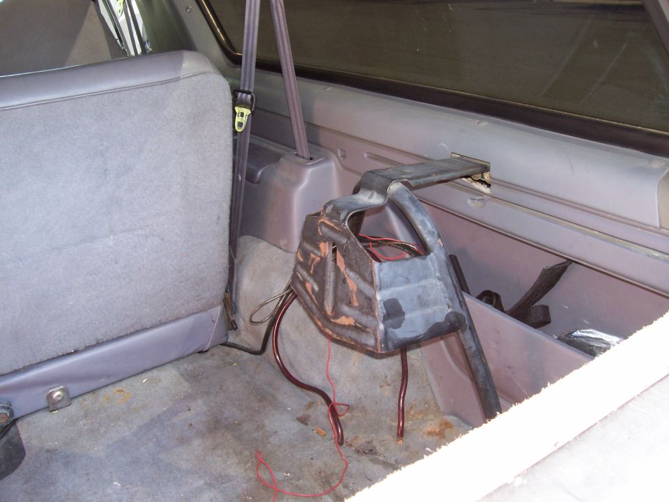 1994 Ford Bronco interior cargo area with gray seat and metal bracket