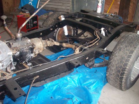 1978 Jeep CJ5 - The frame of a 1978 Jeep CJ5 is shown, with its transmission and suspension visible.
