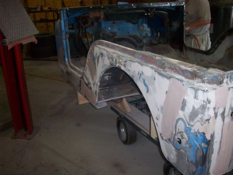 1978 Jeep CJ5 - This blue Jeep body is in a workshop, being prepared for repair and painting.