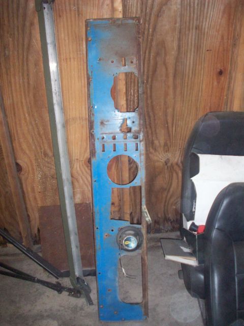 1978 Jeep CJ5 - A blue metal panel, possibly from a vehicle's dashboard, is shown with various cutouts and a speaker.