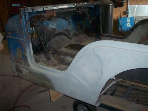 1978 Jeep CJ5 - This 1978 Jeep CJ5 body is undergoing restoration, with primer on the fender and the interior stripped bare.