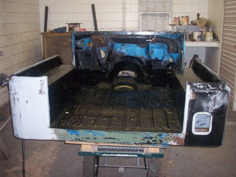 1978 Jeep CJ5 - The rear tub and firewall of a disassembled Jeep CJ-5 are visible, resting on a cart.
