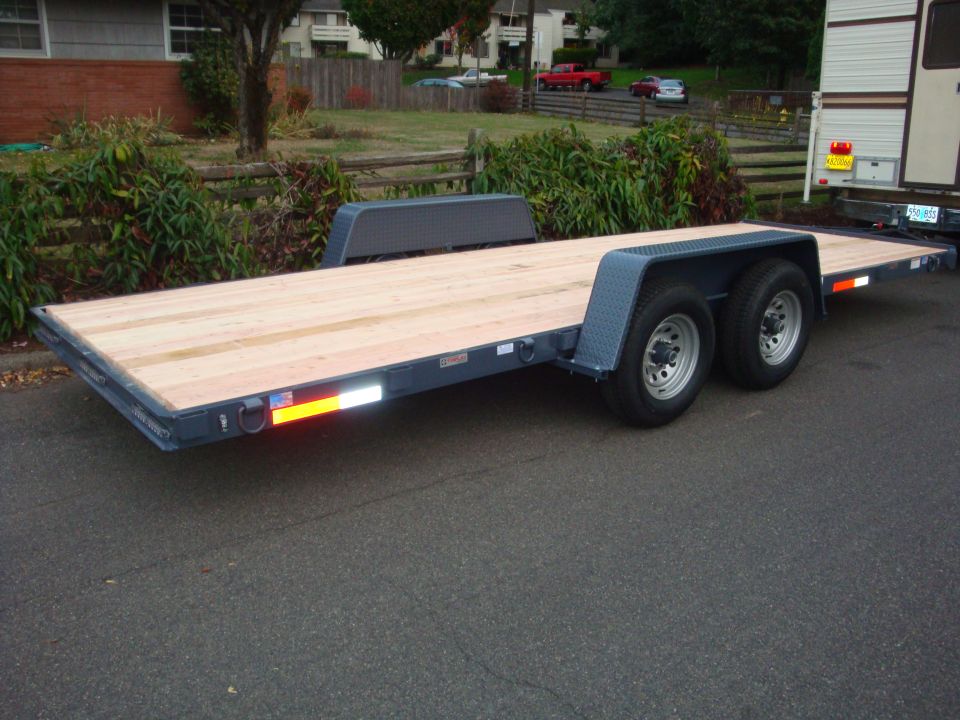 Flatbed trailer with wooden deck and dual axles