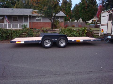 1988 Ford F-350 - Flatbed trailer with wooden deck and dual axles parked on a residential street.