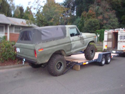 1988 Ford F-350 - This lifted Ford Bronco is being transported on a trailer.