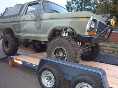 1988 Ford F-350 - This lifted Ford Bronco is loaded onto a trailer, its off-road modifications and appearance.