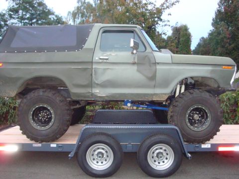 1988 Ford F-350 - This lifted truck, likely a 1978 Ford Bronco, is shown on a trailer with its soft top in place.