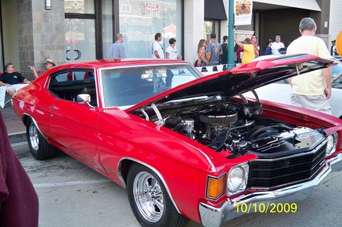 1985 Ford Bronco - Red 1970 Chevrolet Chevelle SS coupe with hood open at an outdoor event.