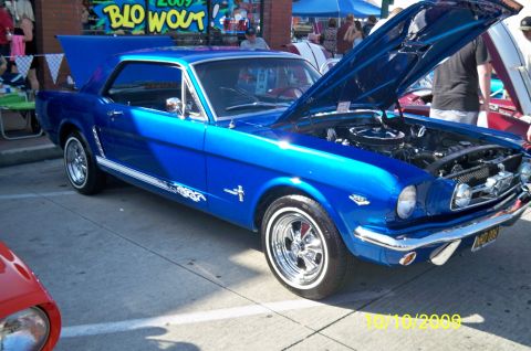 1985 Ford Bronco - This blue 1965 Ford Mustang coupe was displayed with its hood and trunk open.