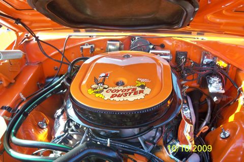1985 Ford Bronco - The engine bay is painted orange and features an air cleaner with 'Coyote Duster' graphics.