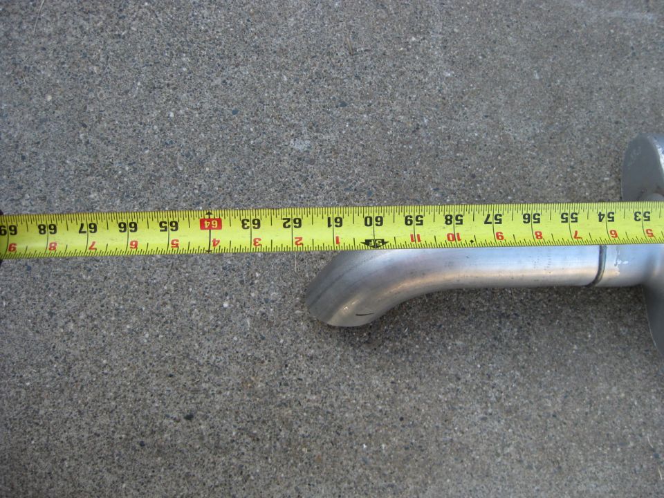 Exhaust pipe measured with a yellow tape measure showing approximately 64 inches