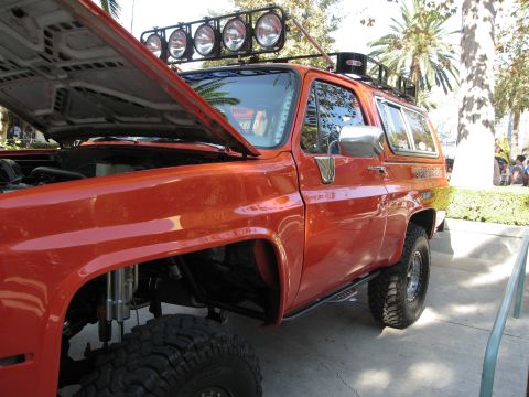 1986 Ford Bronco - Orange 1986 Ford Bronco modified for off-roading, hood is open.