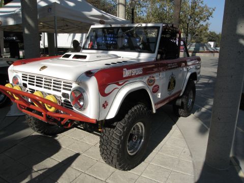 1986 Ford Bronco - This modified Ford Bronco is displayed at an outdoor event with tents in the background.