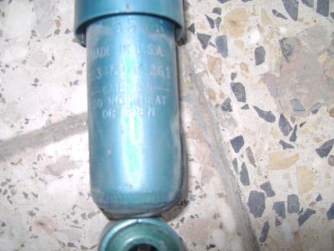 1998 Ford Crown Victoria - Close-up of a blue shock absorber, showing 'MADE IN U.S.A.' and part number '63-4151-32-261'.
