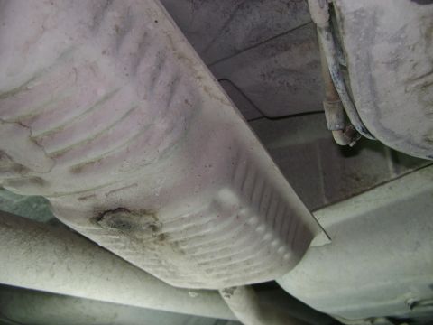 1998 Ford Crown Victoria - Underside view of vehicle exhaust system components, showing mufflers and pipes.
