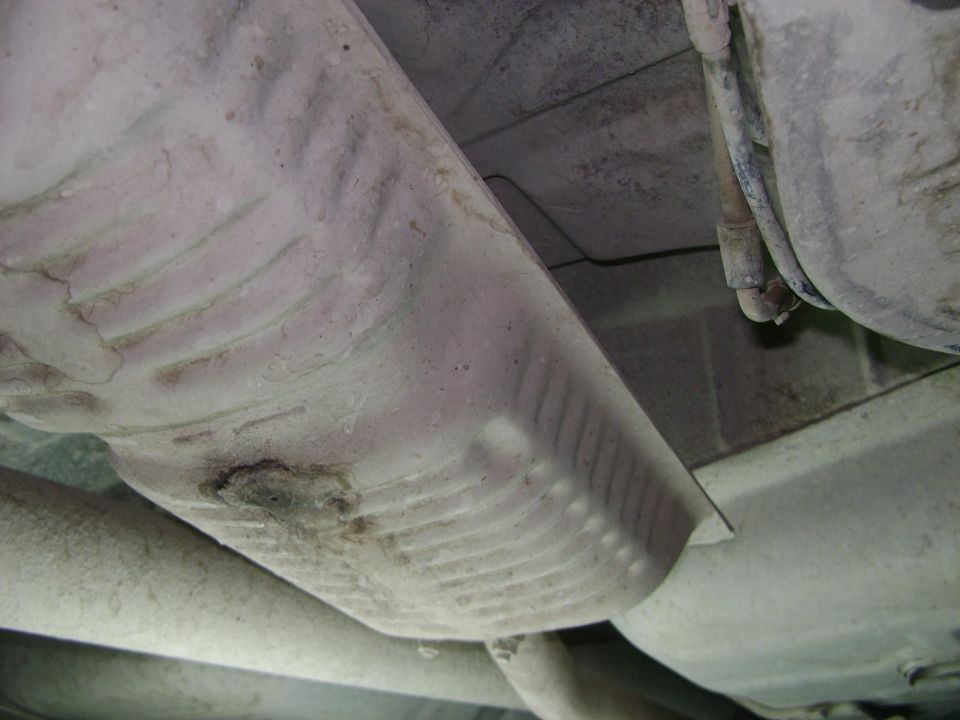 Underside view of vehicle exhaust system components, including mufflers and pipes