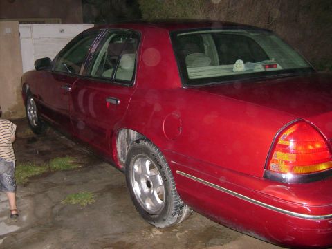 1998 Ford Crown Victoria - Rear side view of a red 1998 Ford Crown Victoria sedan.