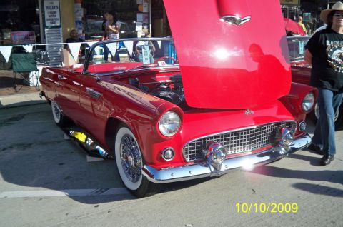1985 Ford Bronco - A red 1955 Ford Thunderbird convertible is displayed with its hood open at an outdoor event.