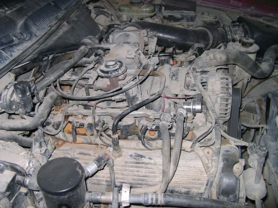 Engine compartment with hoses and wiring visible