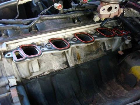 1998 Ford Crown Victoria - Close-up view of an engine's intake manifold gasket removed for maintenance.