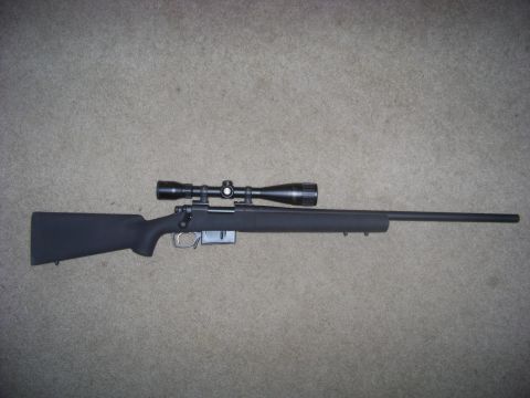 1995 Mercury Grand Marquis - Bolt-action rifle with scope.