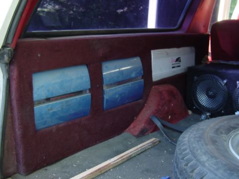 1989 Ford C-350 (Centurion Conversions) - Custom interior paneling with audio equipment and vents is installed in the rear of a vehicle.