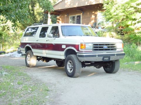 1989 Ford C-350 (Centurion Conversions) - This two-tone Ford SUV features a prominent maroon stripe along its side. The body style is indicative of the late 1980s to early 1990s For…