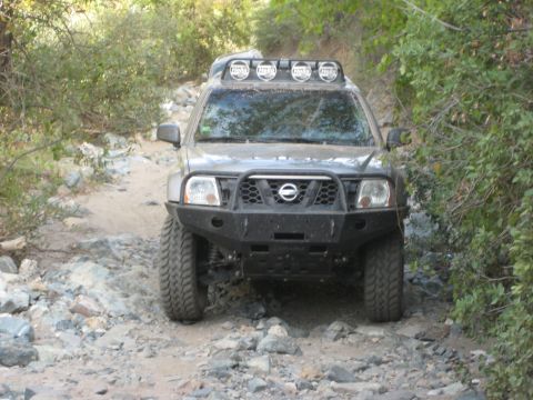 1996 Ford Bronco - This modified Nissan Xterra navigates a challenging, rocky off-road path.