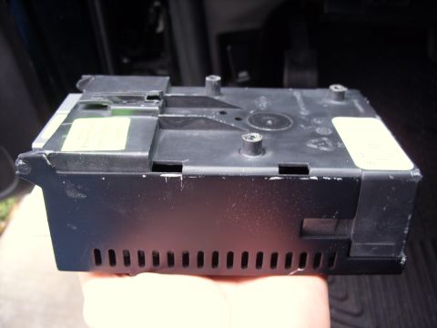 2005 Ford Crown Victoria - A black electrical component with visible vents and labels, likely an interior car part.