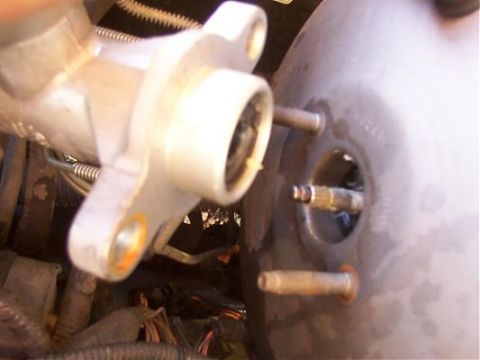 1995 Ford C-350 (Centurion Conversions) - Close-up of a brake master cylinder and booster, likely from a vehicle's engine bay.