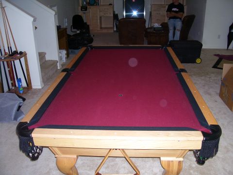 1991 Ford Bronco - A pool table is set up in a room with a staircase and furniture visible in the background.