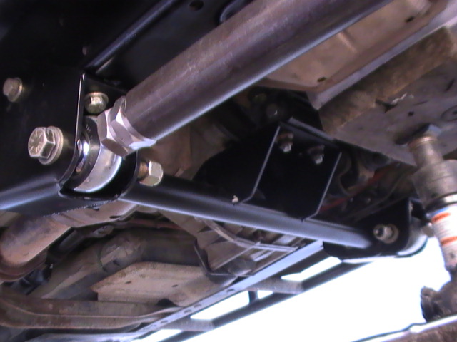Custom suspension links and brackets mounted underneath a vehicle