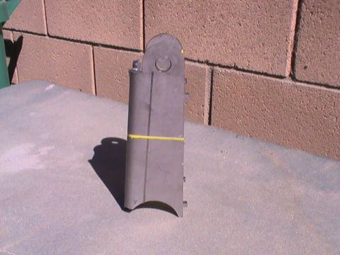 1997 Ford Ranger - A fabricated metal bracket with a yellow marking is shown against a brick wall.