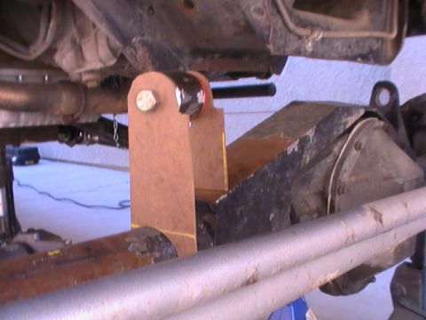 1997 Ford Ranger - Close-up of a custom bracket being installed on a vehicle's frame, near the rear axle.