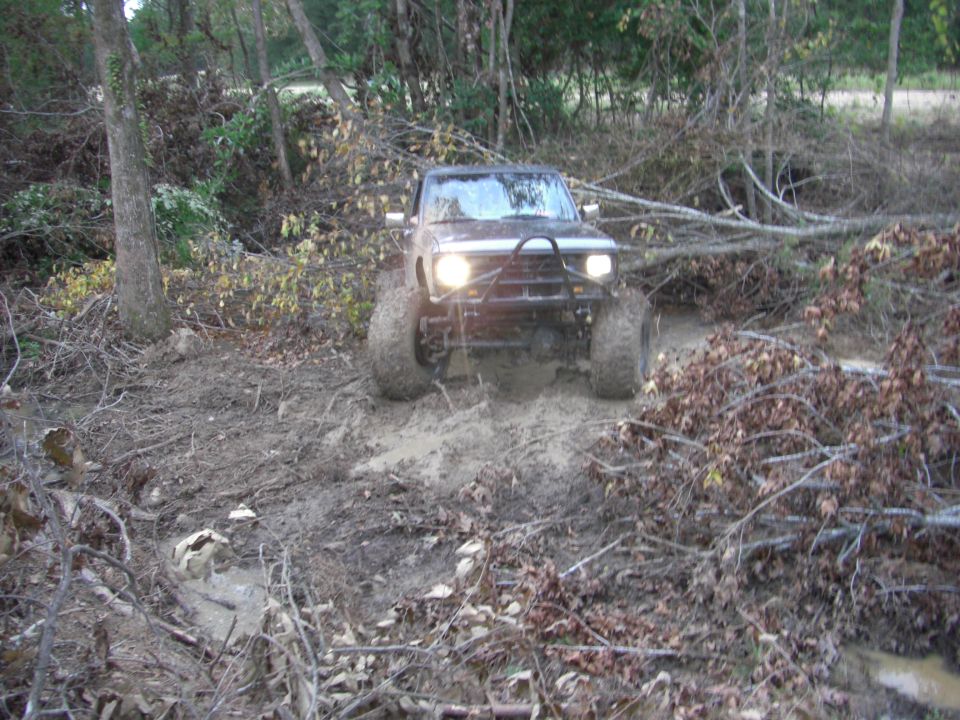 1984 Ford Bronco II on muddy trail with large tires