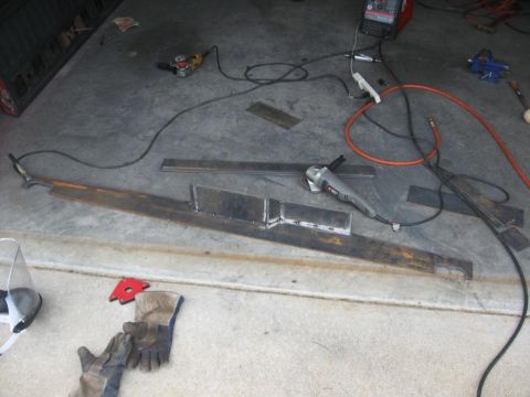 1995 Ford F-150 - Metal fabrication project with grinders, welding gear, and raw materials laid out.