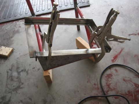1995 Ford F-150 - A metal fabrication project is underway, secured with locking pliers and supported by sawhorses.