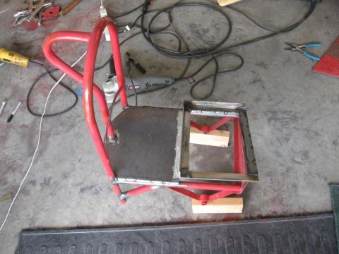 1995 Ford F-150 - A welding cart is shown in a garage setting with tools and electrical cords nearby.