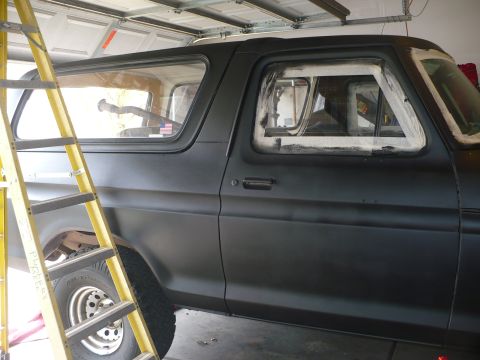 1979 Ford Bronco - This Ford Bronco is undergoing some work, with tape around the windows and a ladder nearby.