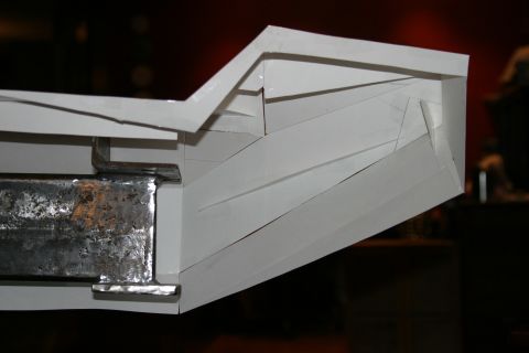 1987 Suzuki Samurai - Close-up view of a white bumper component, revealing its underlying metal structure.