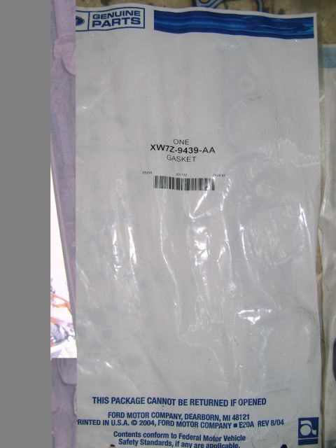 1998 Ford Crown Victoria - This is a photo of a sealed package containing a Ford intake gasket, labeled with part number XW7Z-9439-AA.