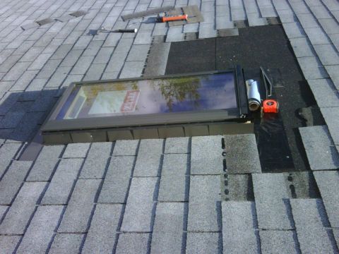 1996 Ford Bronco - Roof repair work underway, a skylight and various tools for installation.