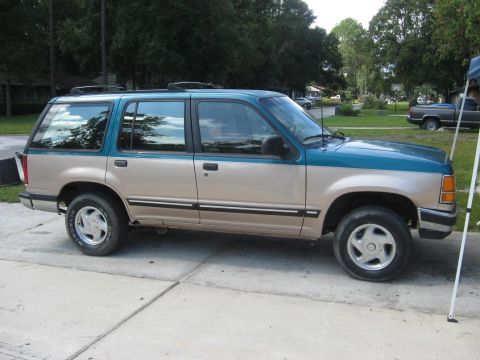 1992 Ford Explorer - This two-tone 1992 Ford Explorer is shown from the side, parked on a concrete driveway.