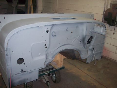1978 Jeep CJ5 - The firewall of a Jeep CJ is shown after being primed, resting on a cart in a workshop.