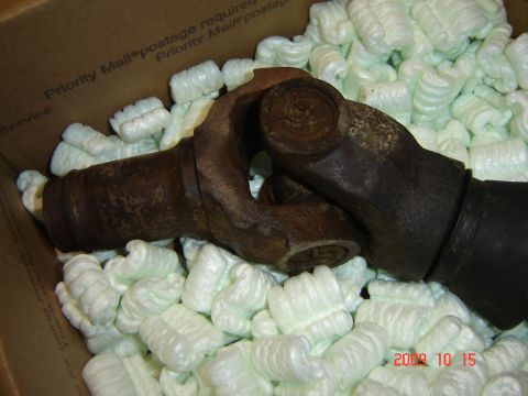 1993 Ford Bronco - Two driveshaft U-joints are packed in white peanuts inside a cardboard box.